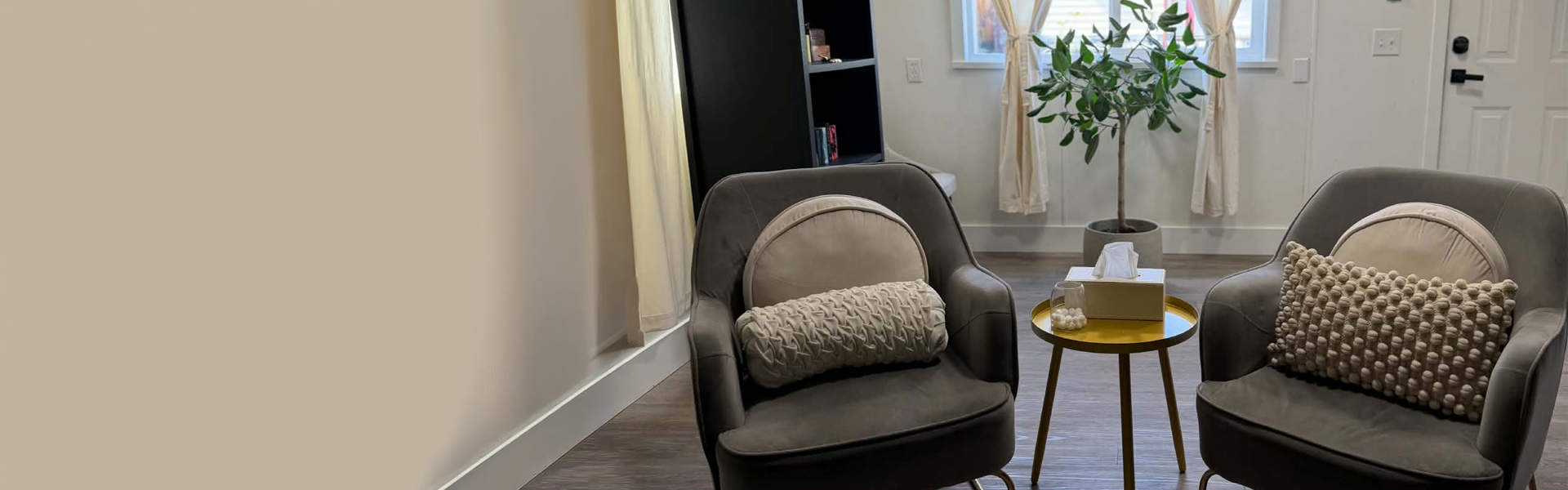 A cozy reading room with two chairs facing each other around a small round table