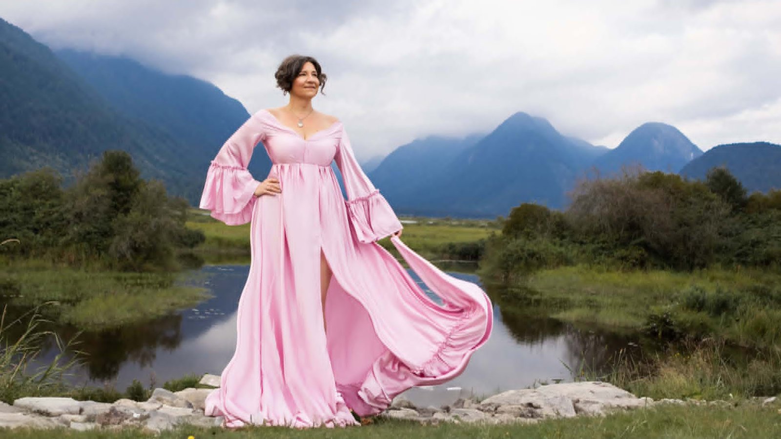 Mandy Kuelz in a flowing pink gown by a misty mountain lake